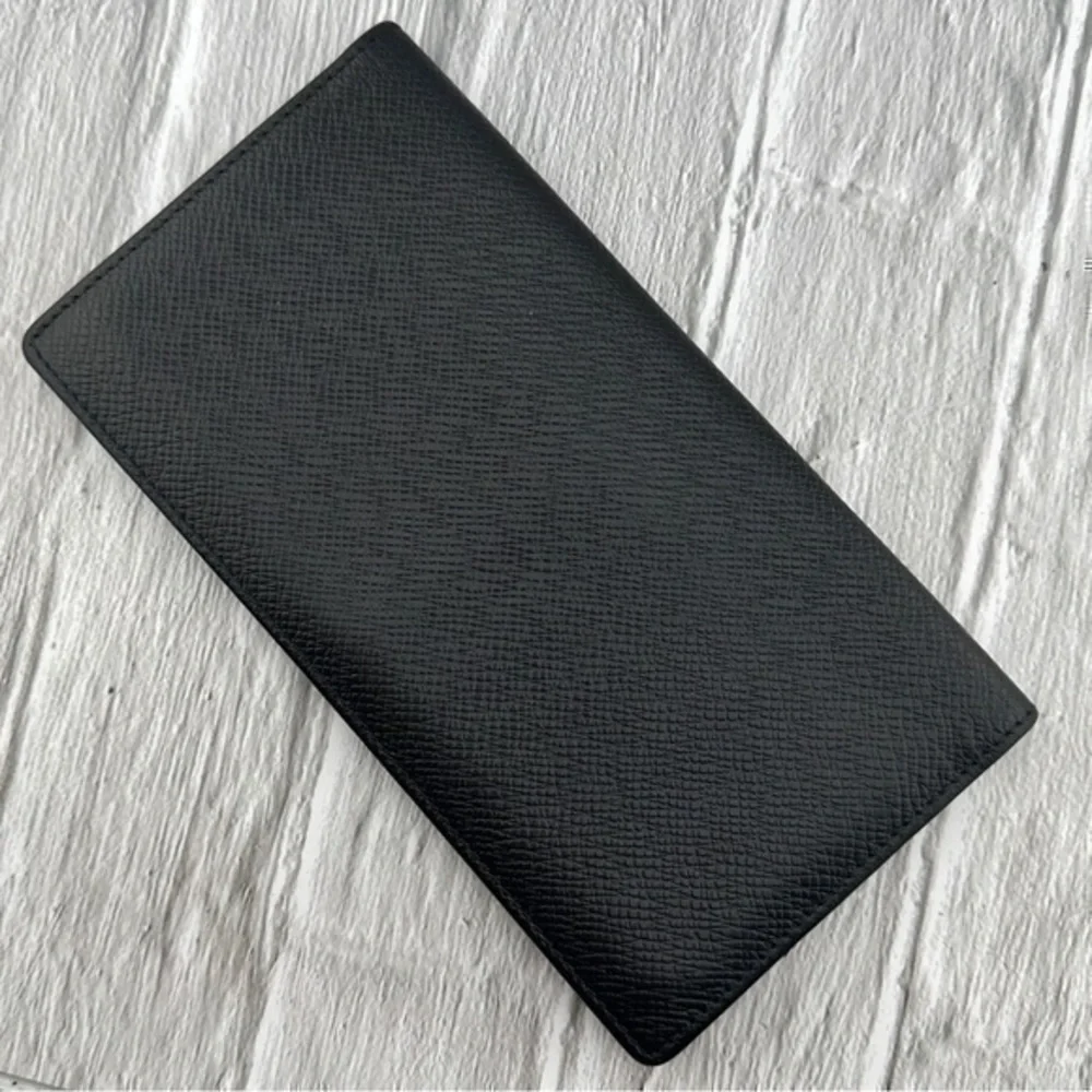 AUTHENTIC Louis Vuitton Taiga wallet. Previously owned. Color: Black.